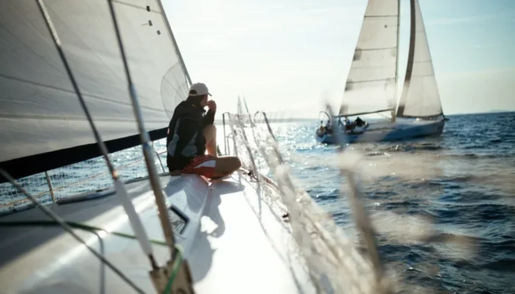 Young handsome man relaxing on his sailboat